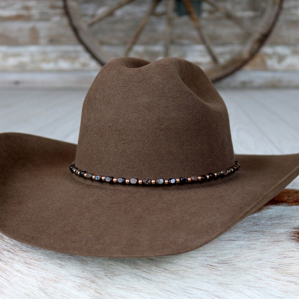 a brown hat on a white surface