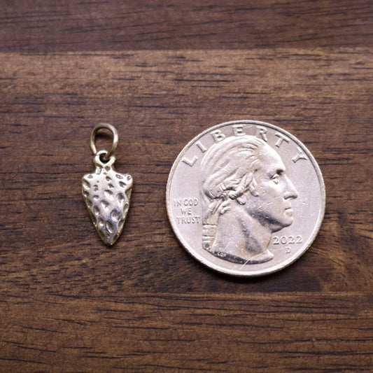 a coin and a small gold object