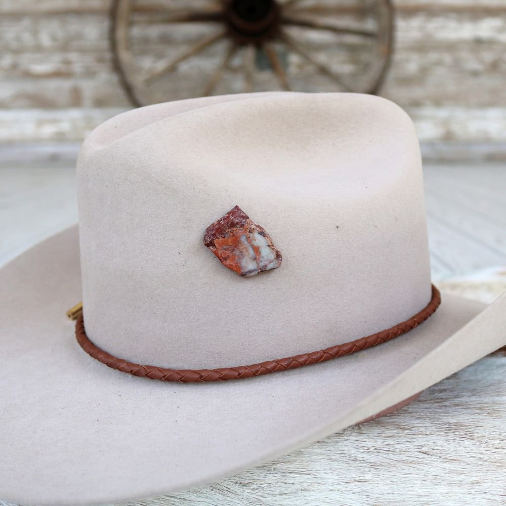 a hat with a stone on it