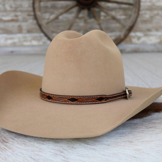 a brown hat on a white surface