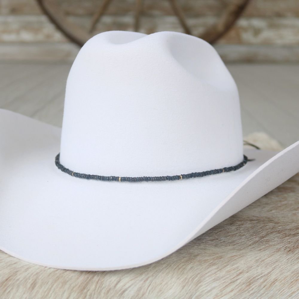 a white cowboy hat on a fur surface
