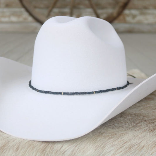 a white cowboy hat on a fur surface