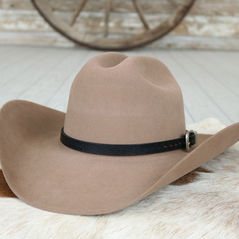 a brown cowboy hat on a white fur rug