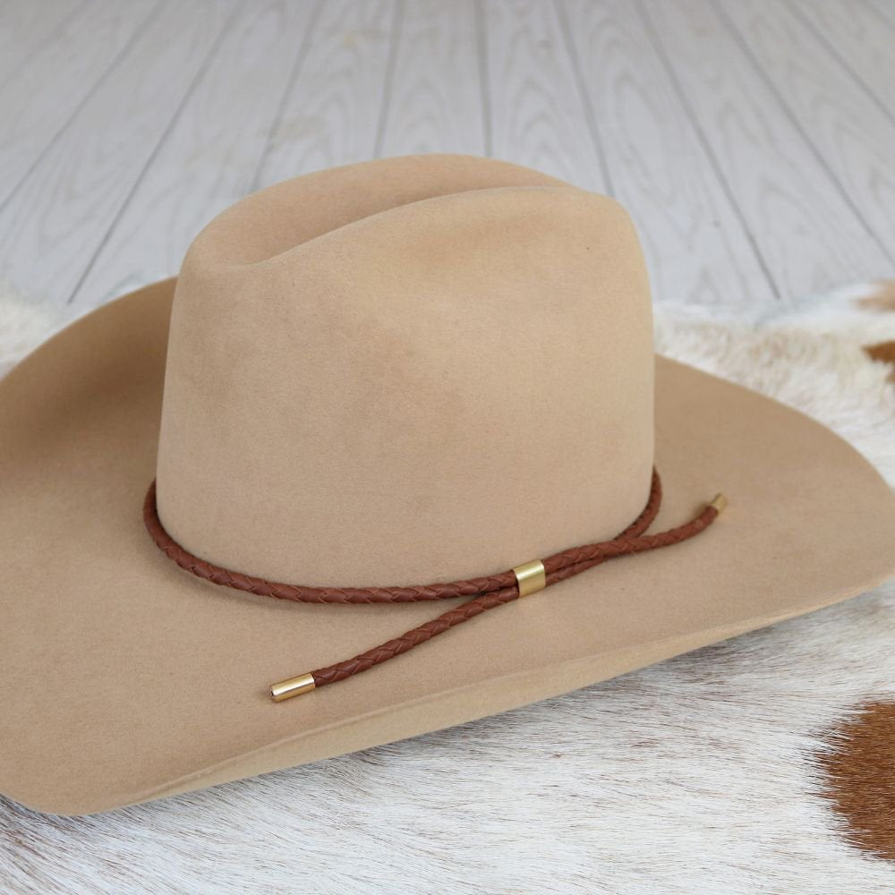 a brown hat on a white rug