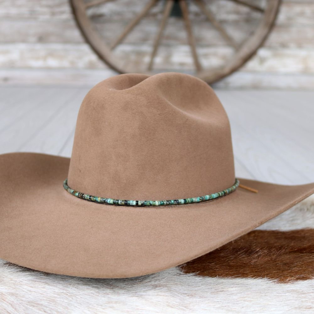 a brown hat on a white rug