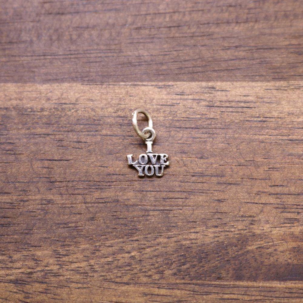 a gold pendant with a word on it