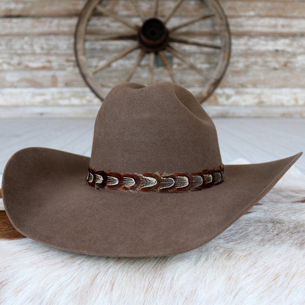 a brown hat on a white fur surface