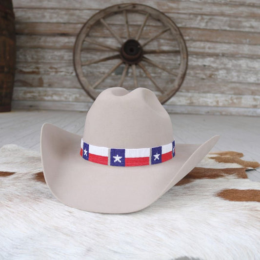 a cowboy hat on a cowhide rug
