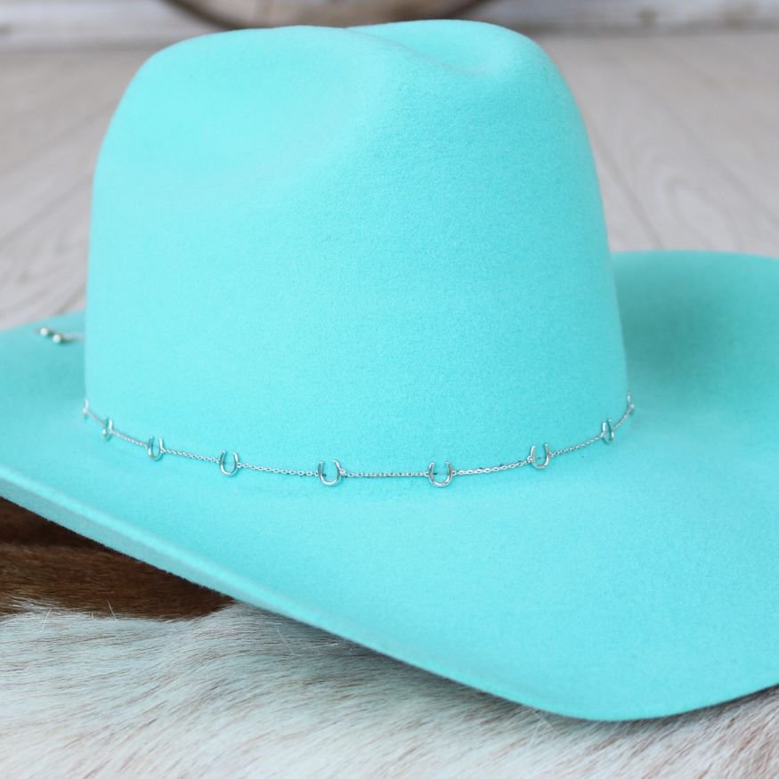 a blue cowboy hat on a white fur