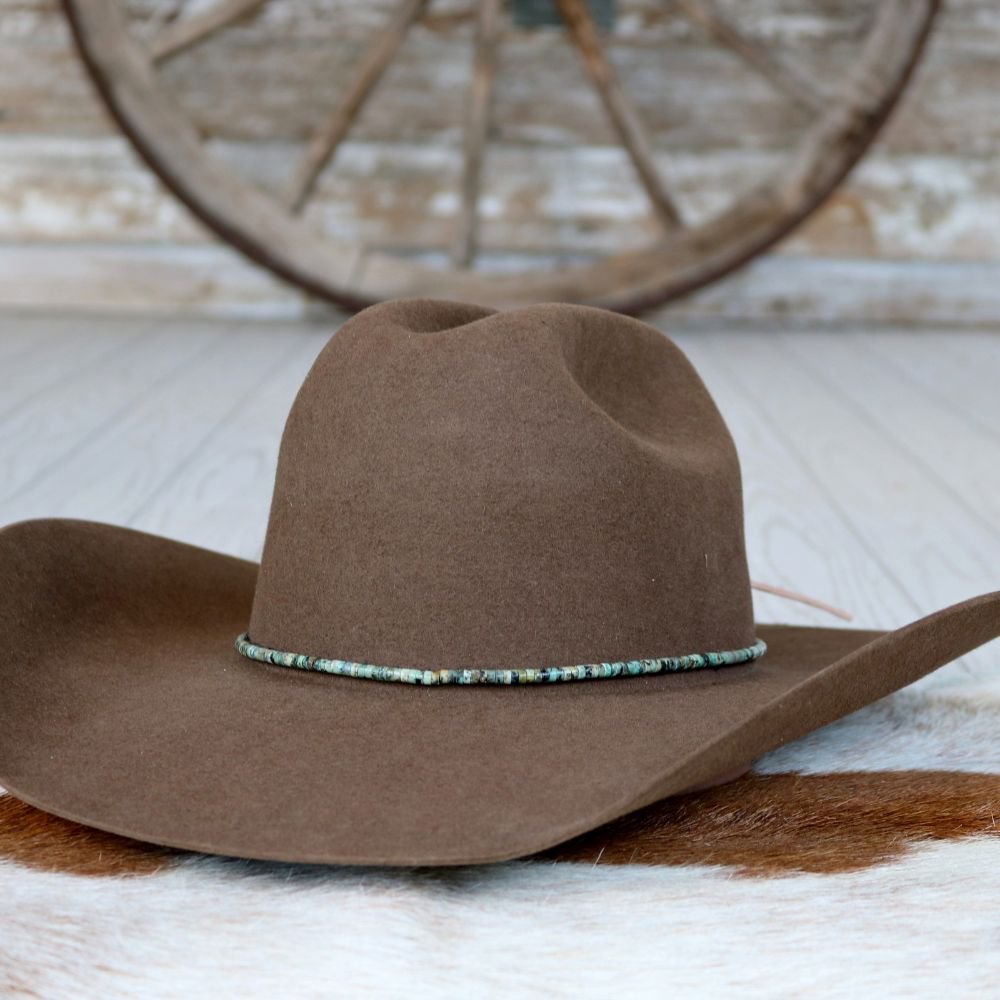a brown hat on a white rug