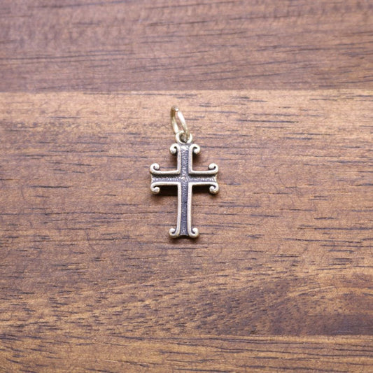 a cross on a wood surface