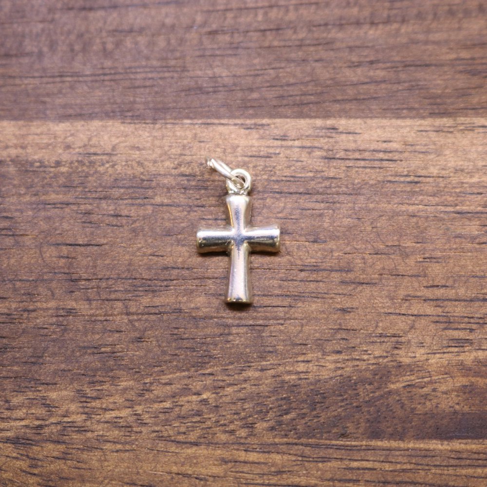 a cross on a wood surface