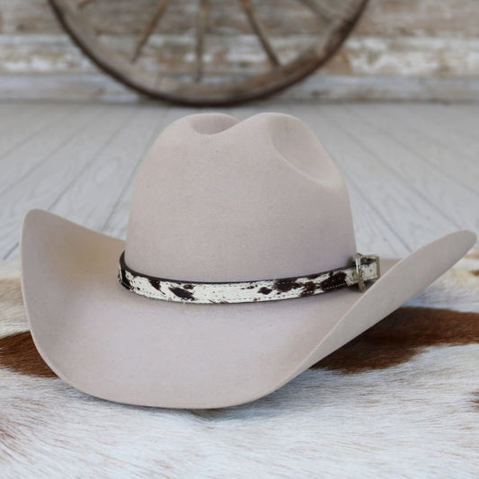 a hat on a cowhide rug