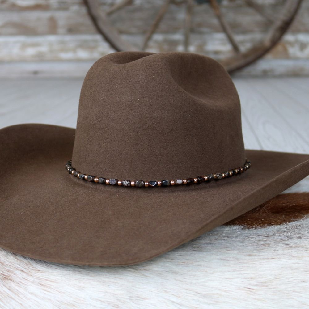 a brown hat on a white fur surface