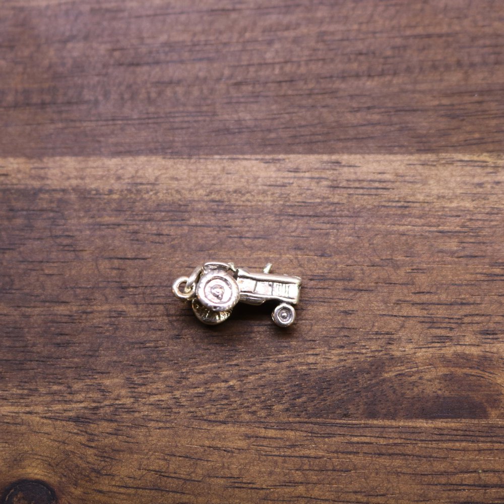 a small metal object on a wood surface