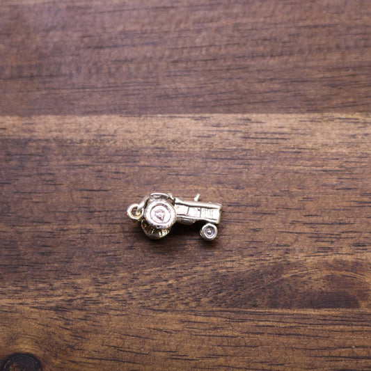 a small metal object on a wood surface