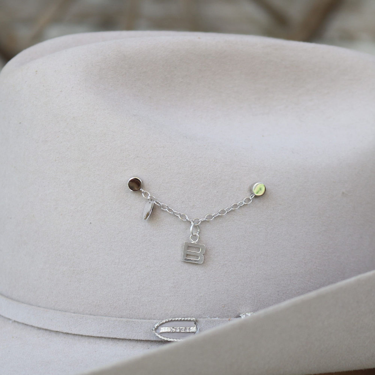 a hat with a silver chain on it