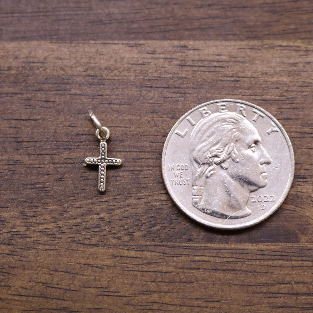 a coin and a silver cross