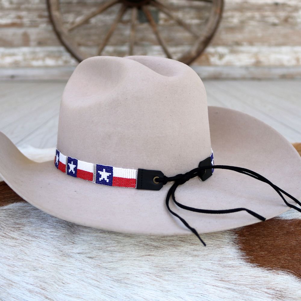 a cowboy hat on a cowhide rug