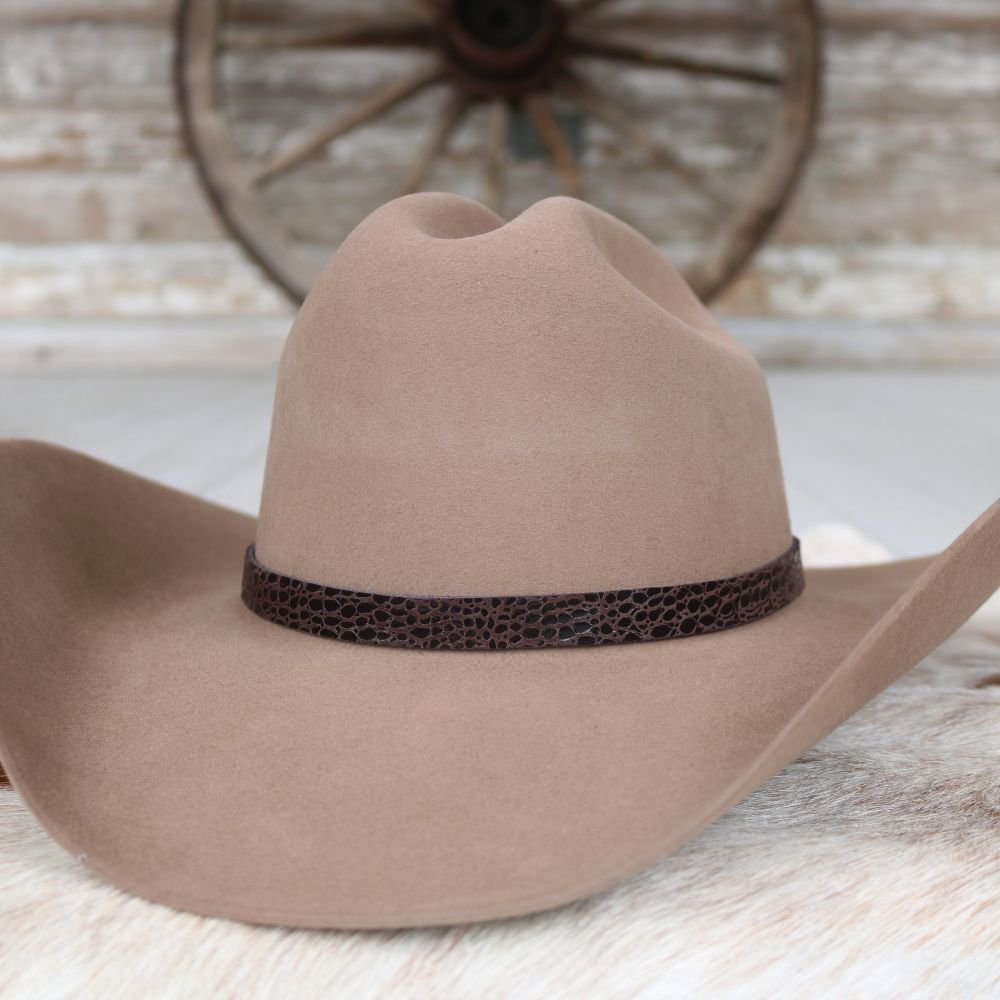 a brown cowboy hat with a leather band