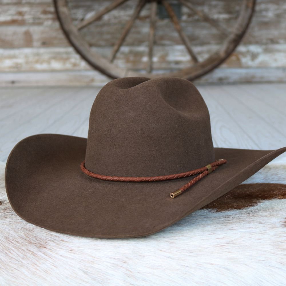 a brown hat on a white fur surface